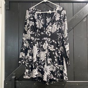 Black and white floral romper. V neck with long sleeves